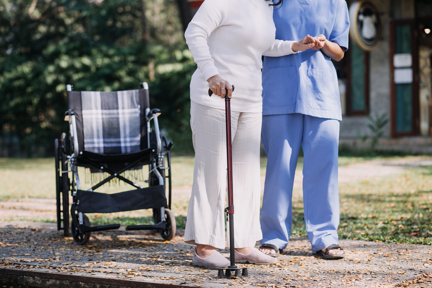 Asian young woman nurse at nursing home take care disabled senio
